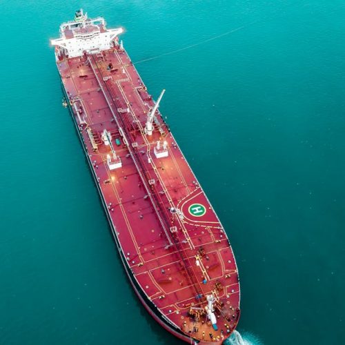 Aerial shot of an oil tanker cruising through the ocean, emphasizing maritime transport.