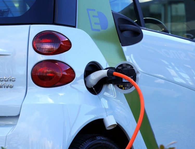 Close-up of an electric car being charged, highlighting eco-friendly transportation.