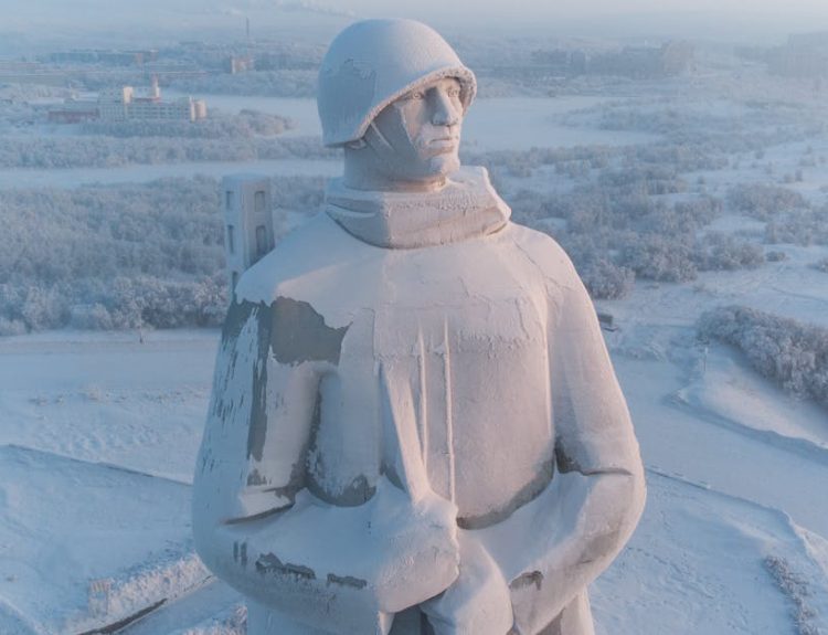 Aerial view of the Alyosha statue in Murmansk, Russia, covered in winter snow.
