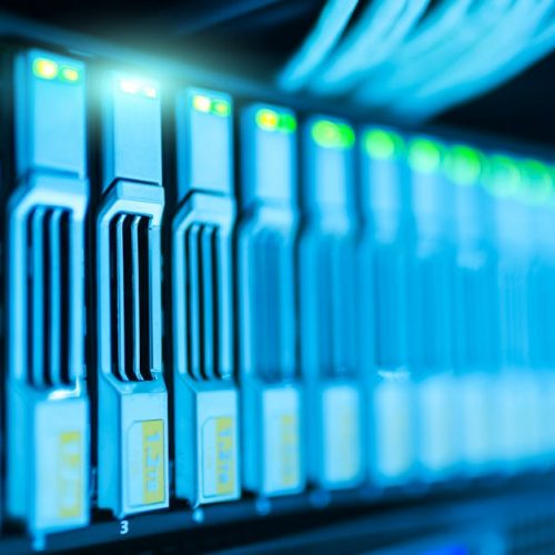 Detailed image of a server rack with glowing lights in a modern data center.