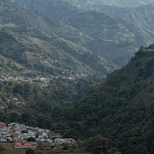 A captivating aerial view of the mountainous landscape in Mérida, Venezuela, showcasing lush greenery and a picturesque town.