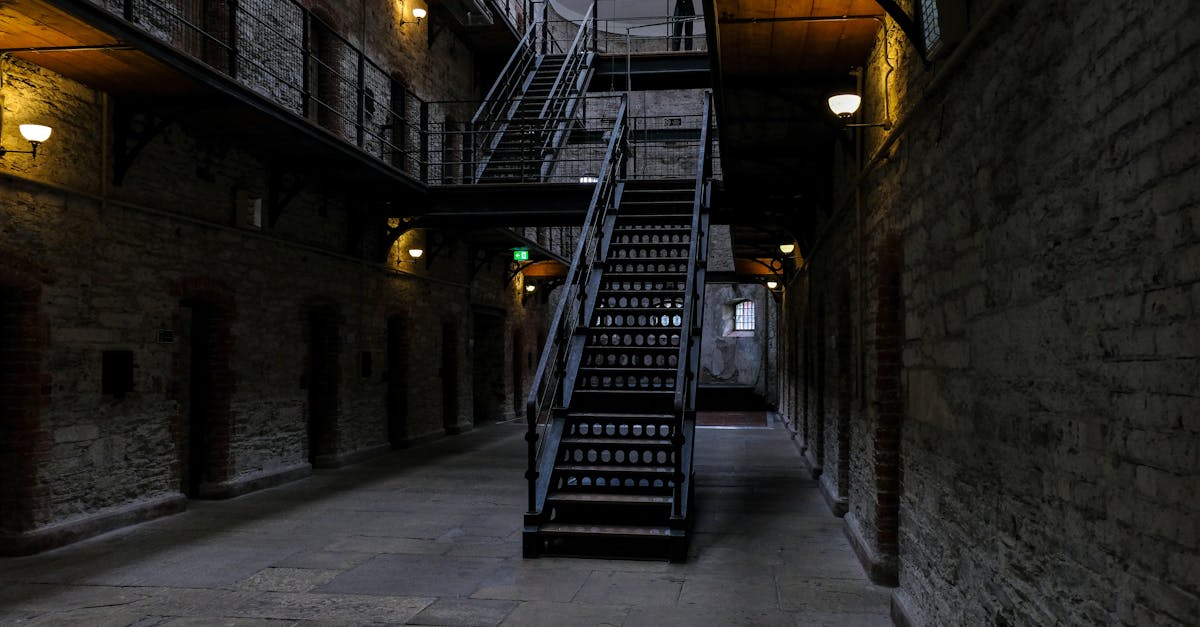 Explore a dimly lit corridor with a historic staircase, atmospheric and intriguing.