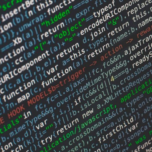 Close-up of colorful programming code displayed on a computer screen.