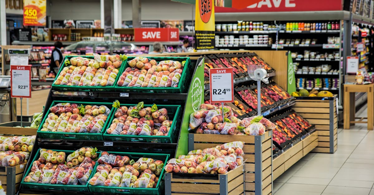 Colorful produce aisle in a supermarket showcasing fresh apples with discount signage.