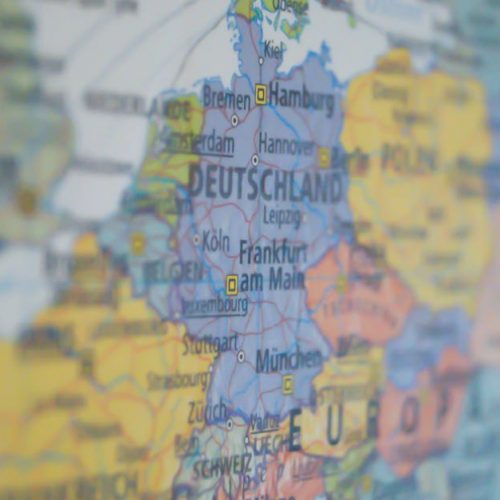 Close-up view of Germany on a colorful world map showing major cities.