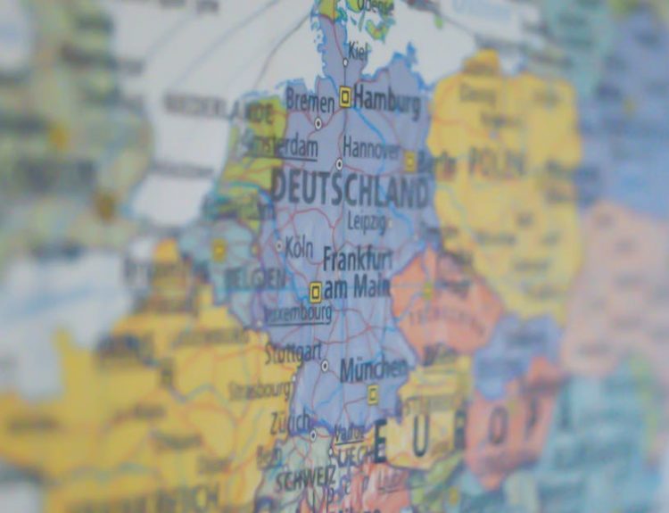 Close-up view of Germany on a colorful world map showing major cities.