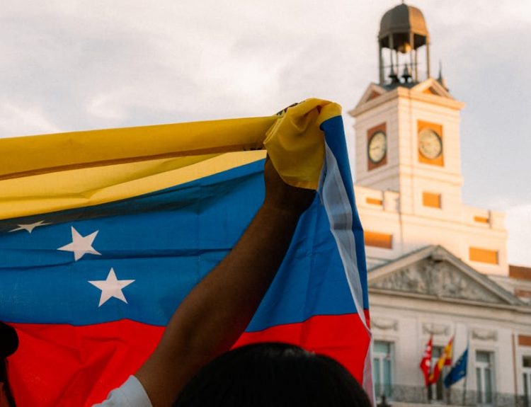 Venezuelan flag waving during a protest at Puerta del Sol, Madrid.