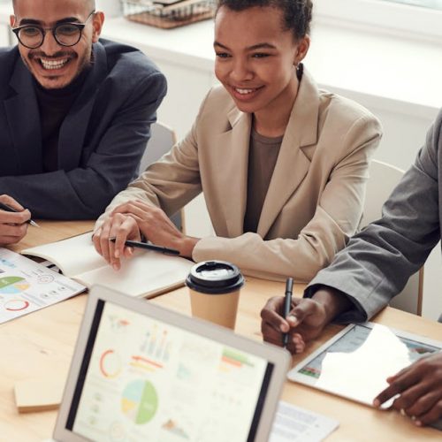 A diverse team of professionals having a meeting in a modern office setting, discussing business strategies.
