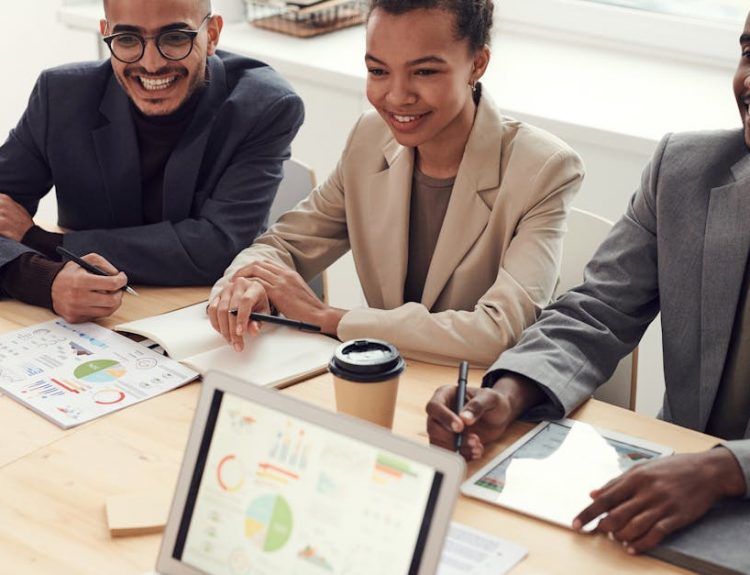 A diverse team of professionals having a meeting in a modern office setting, discussing business strategies.
