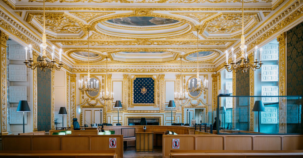 An ornate courtroom with golden details and chandeliers in Rennes, France.