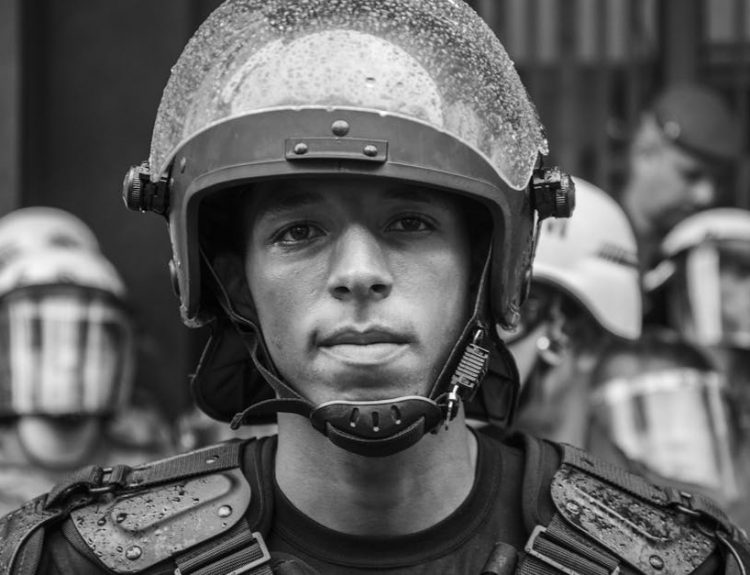Close-up grayscale portrait of a riot police officer in Sao Paulo, Brazil.