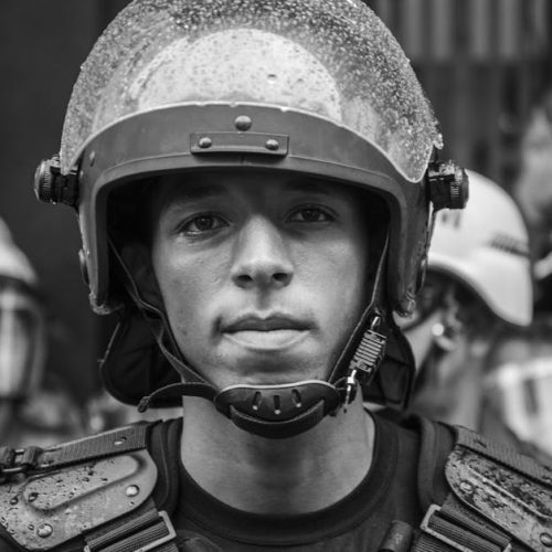 Close-up grayscale portrait of a riot police officer in Sao Paulo, Brazil.
