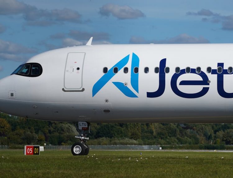 Close-up of a jet airplane parked at Hamburg airport under a clear sky.