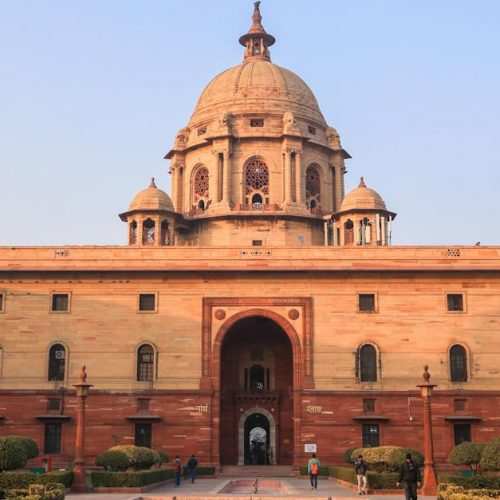 Explore the iconic Rashtrapati Bhavan with its historical architecture in sunny Delhi.