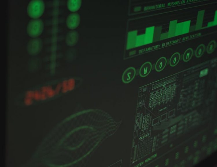 Close-up view of a computer displaying cybersecurity and data protection interfaces in green tones.