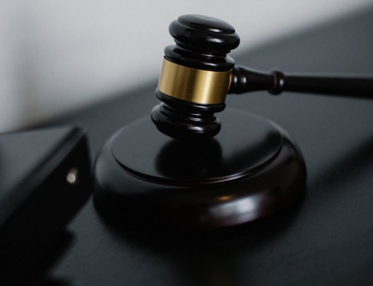 Close-up of a wooden gavel on a desk, symbolizing justice and legal authority.