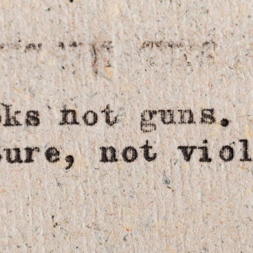 A vintage typewritten quote promoting culture over violence on aged paper.