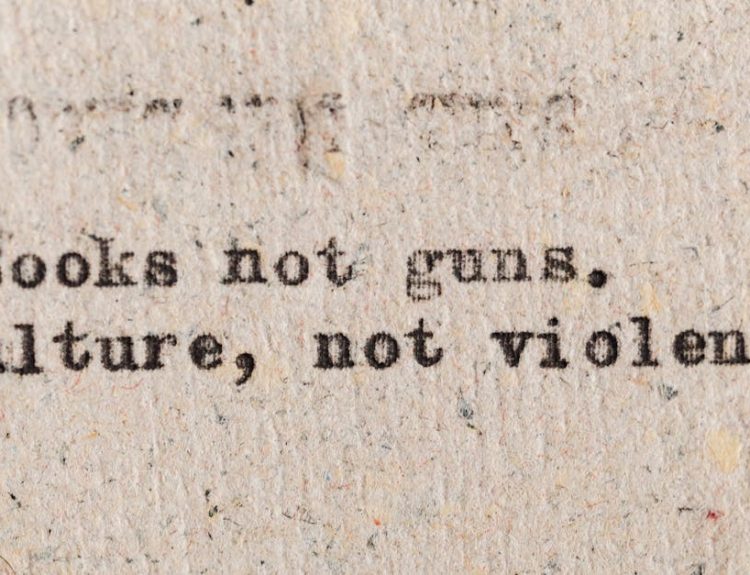 A vintage typewritten quote promoting culture over violence on aged paper.