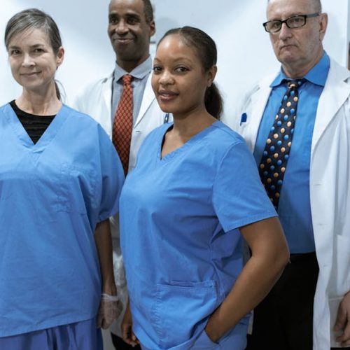 A diverse group of healthcare professionals in hospital uniforms, showcasing teamwork and diversity.