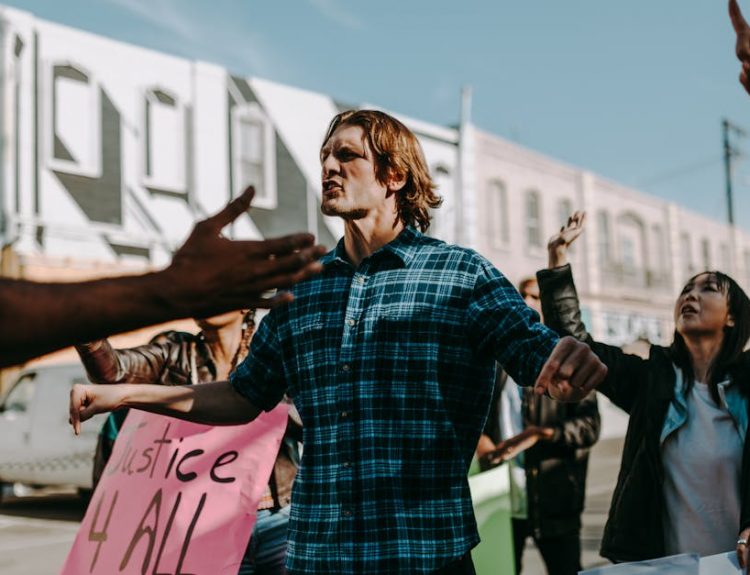 Vibrant street protest scene with diverse group holding justice signs. Encourages change.