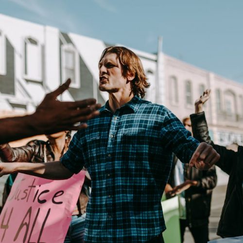 Vibrant street protest scene with diverse group holding justice signs. Encourages change.