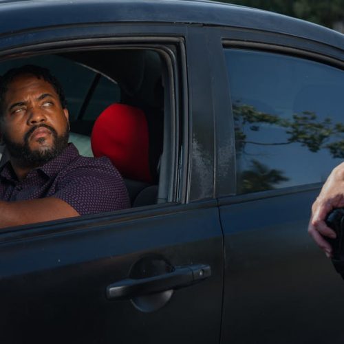 A driver receives a traffic ticket from a police officer for a speeding violation.