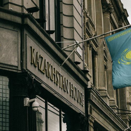 Kazakhstan House facade with flag and emblem in London, showcasing diplomacy and architecture.