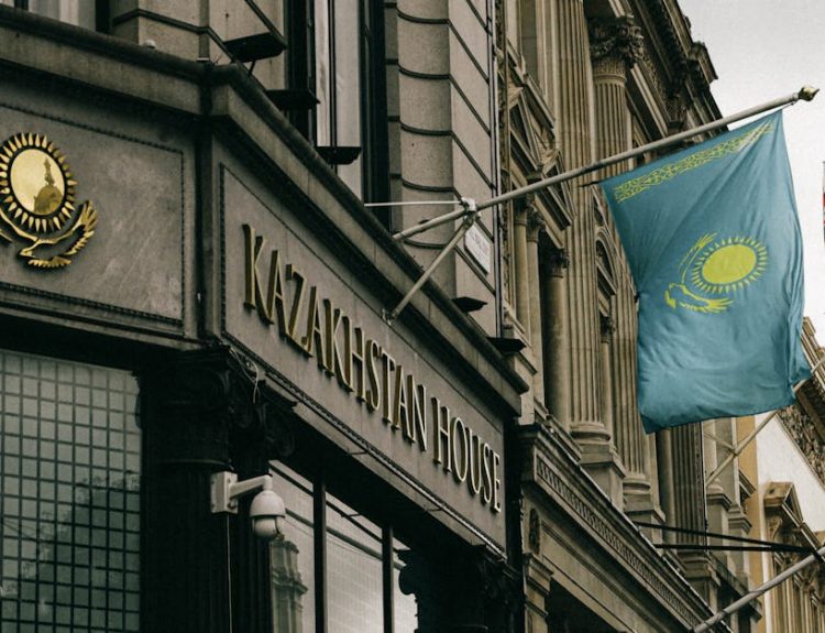 Kazakhstan House facade with flag and emblem in London, showcasing diplomacy and architecture.