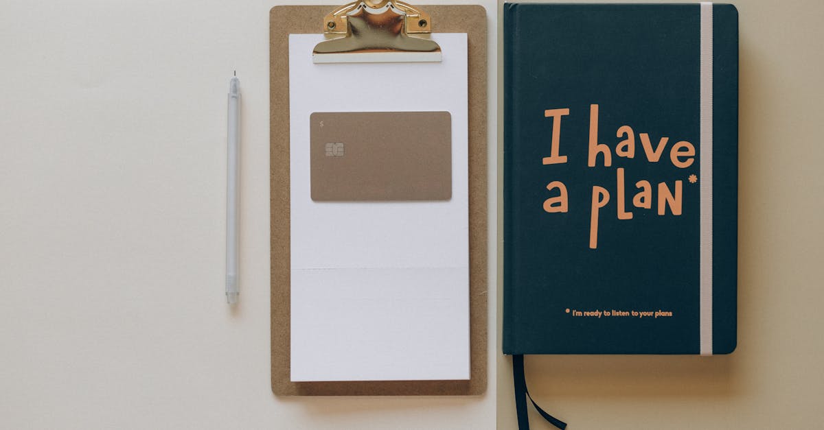 A minimalist office setup featuring a planner, clipboard, card, and pen, perfect for planning and organization.