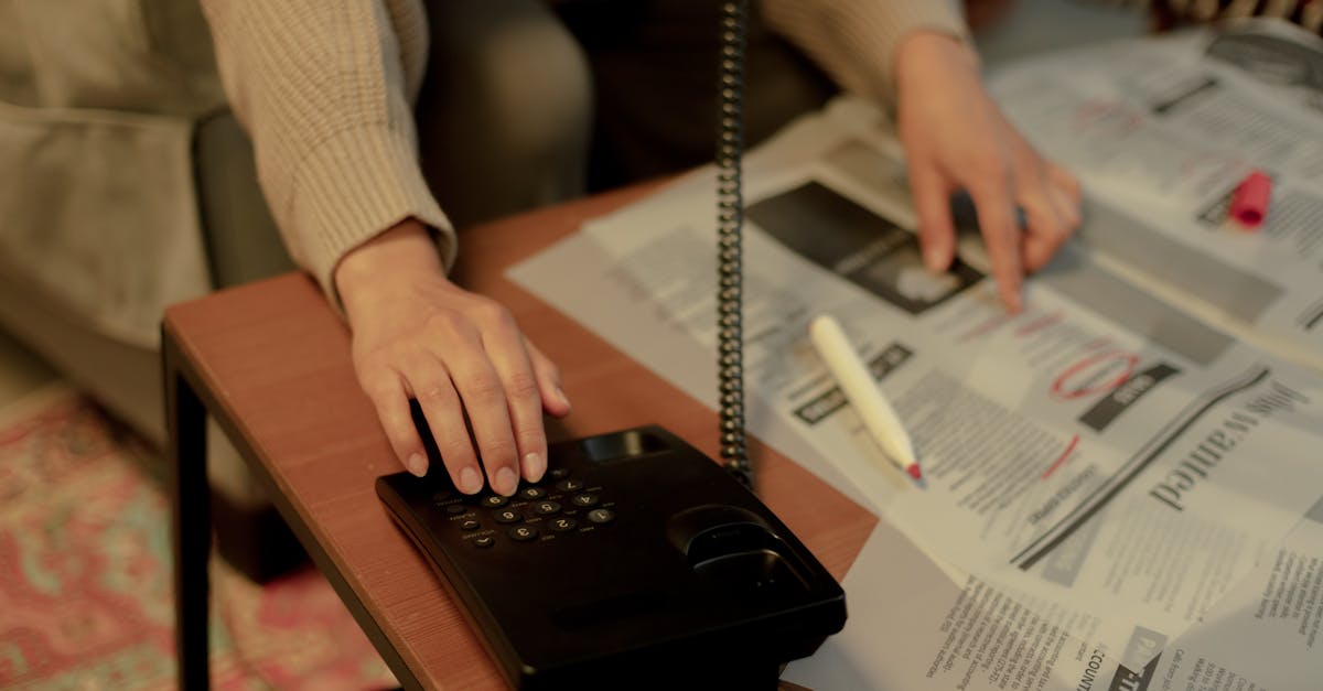 Woman using a landline and newspaper for a job search, highlighting domestic life.