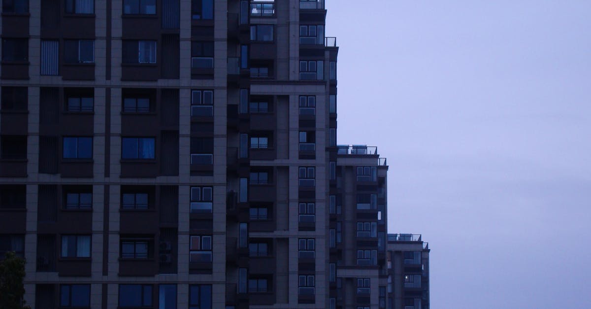 A contemporary skyscraper in a cityscape at dusk showcasing modern architectural design.