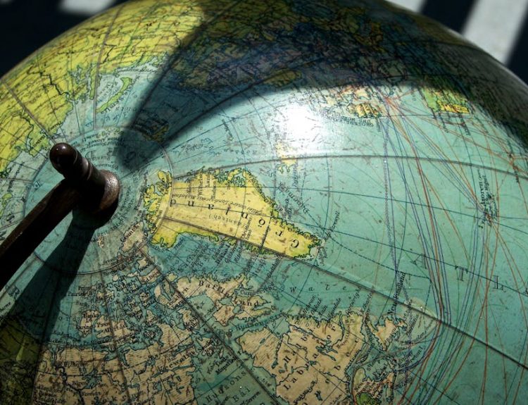 A detailed vintage globe showcasing northern regions with visible longitude and latitude lines.