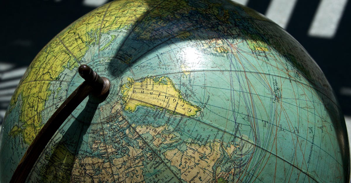 A detailed vintage globe showcasing northern regions with visible longitude and latitude lines.