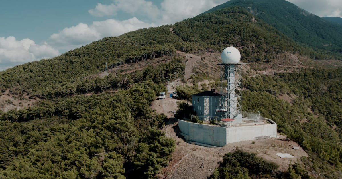 Weather station nestled in the lush mountains of Hatay, Türkiye, under a clear sky.