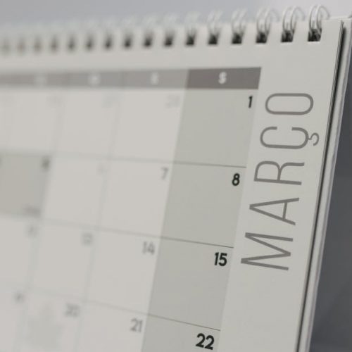 Close-up of a spiral-bound desk calendar showing March in a minimalist style.