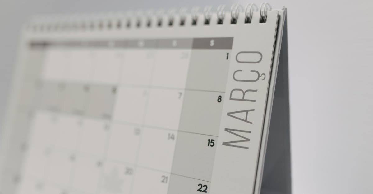 Close-up of a spiral-bound desk calendar showing March in a minimalist style.