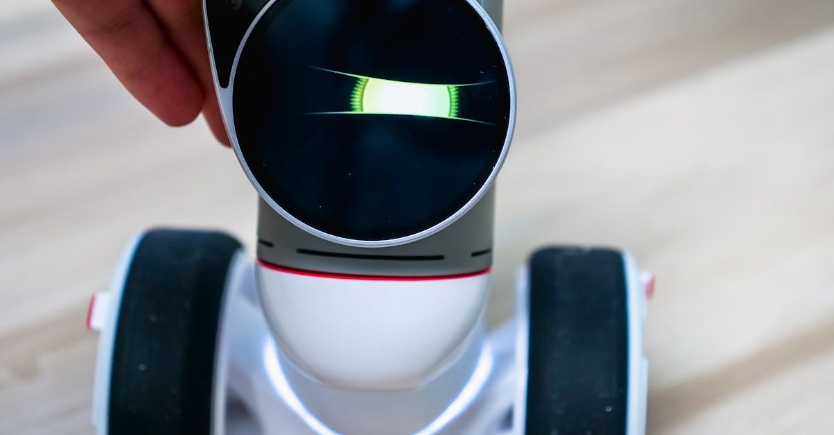 Detailed view of a wheeled robot being touched, showcasing tactile interaction.
