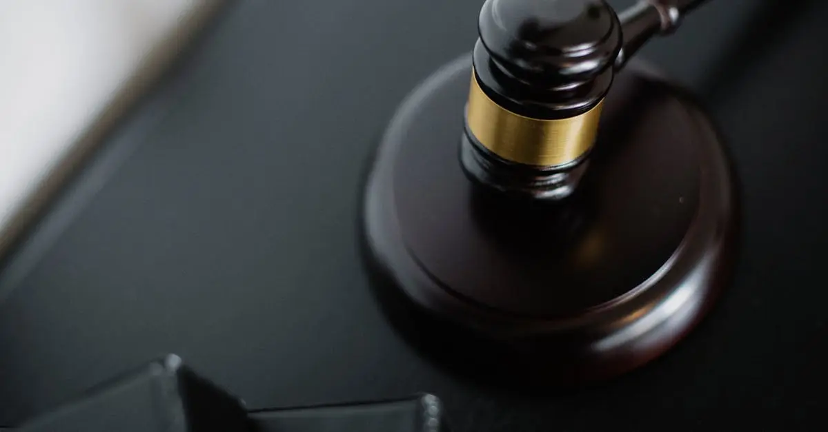 Close-up of a wooden judge's gavel on a black desk, symbolizing justice and law.